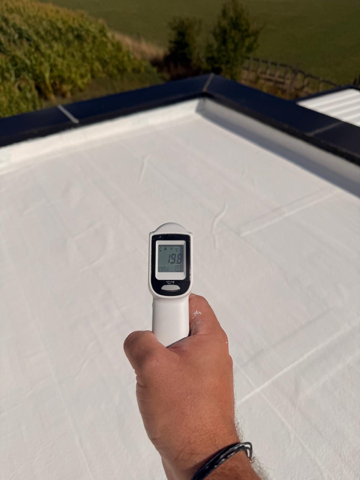 Infrared thermometer reading 19.8 °C on the treated roof