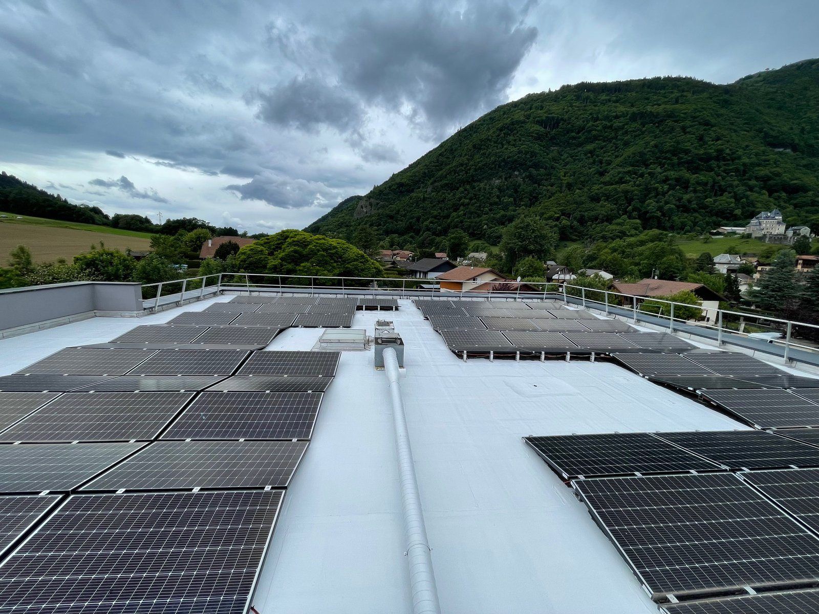 White roof of SET Corp in Saint-Jeoire, service duct and photovoltaic panels, Giffre valley