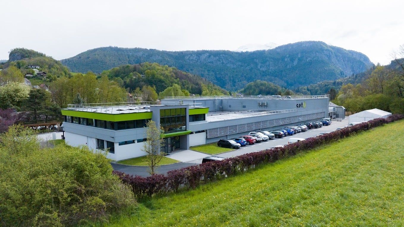 Aerial view of the SET Corp building in Saint-Jeoire, flat roof and mountains of the Giffre valley