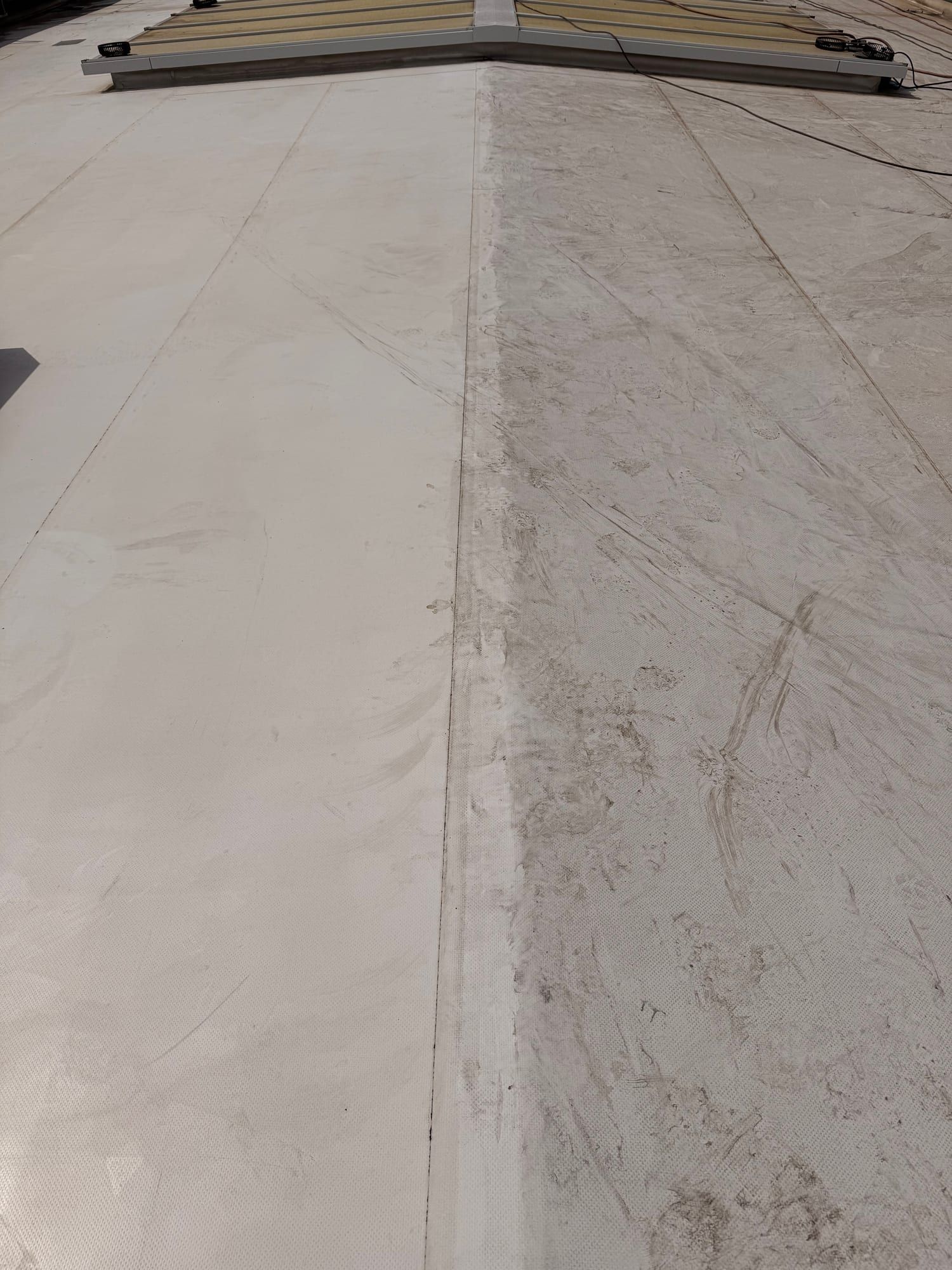Grey PVC membrane before treatment on a roof of the maintenance centre
