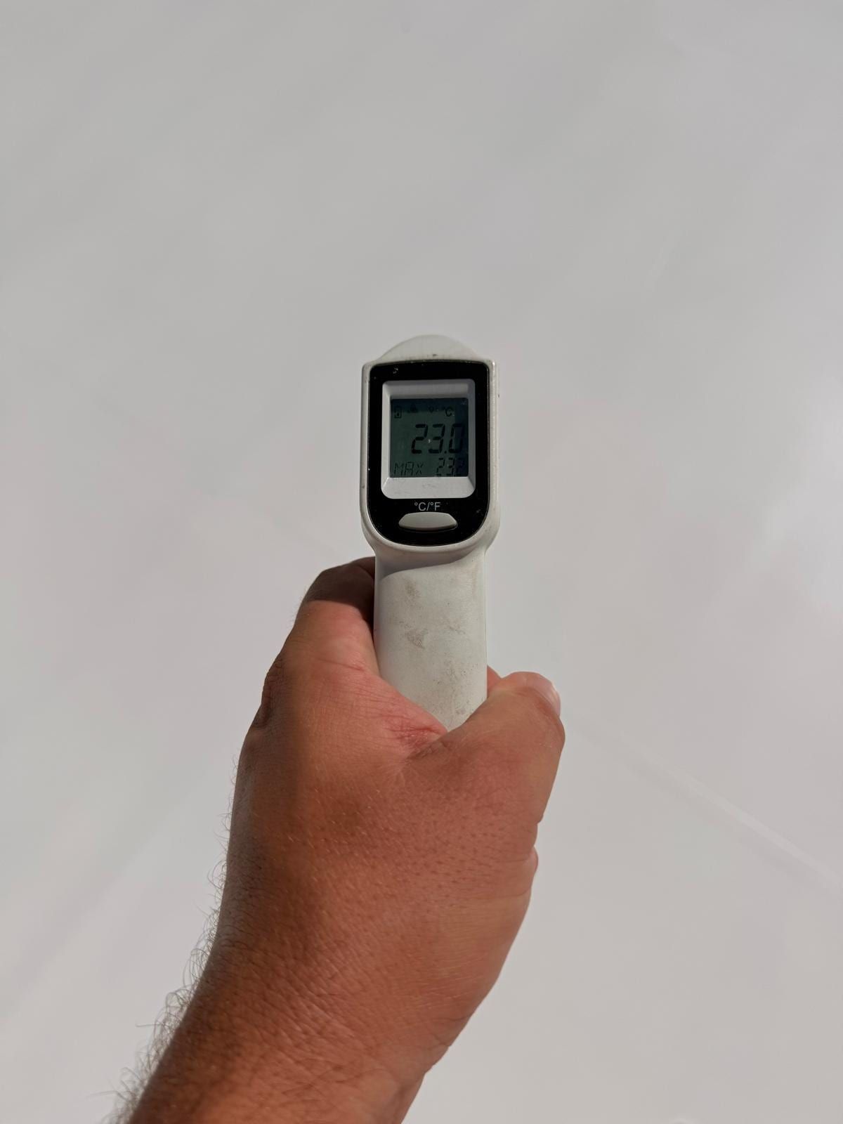 Infrared thermometer reading 23 °C on the treated roof