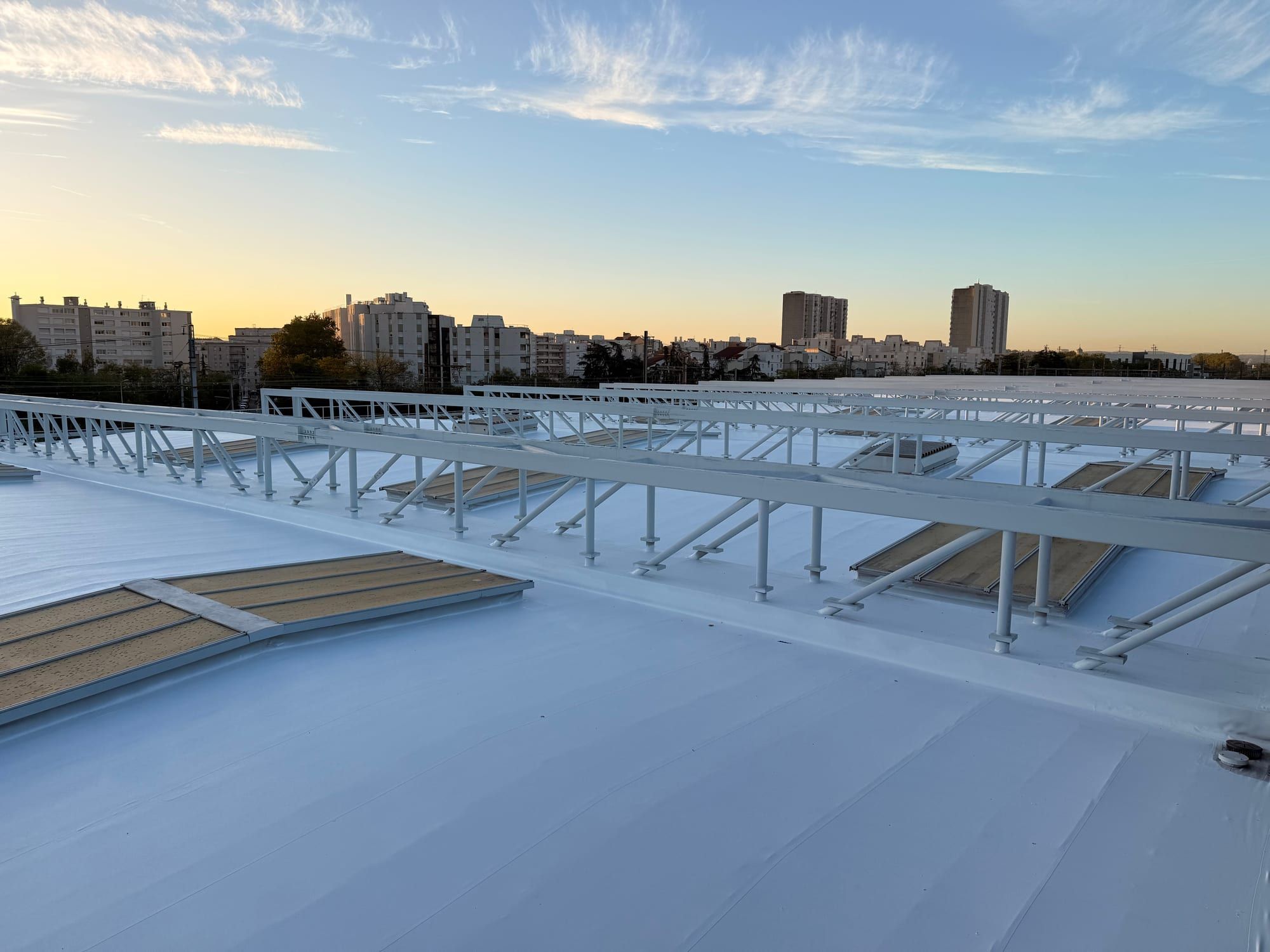 Roof of the SNCF Lyon Gerland maintenance centre treated with a cool roof, late afternoon