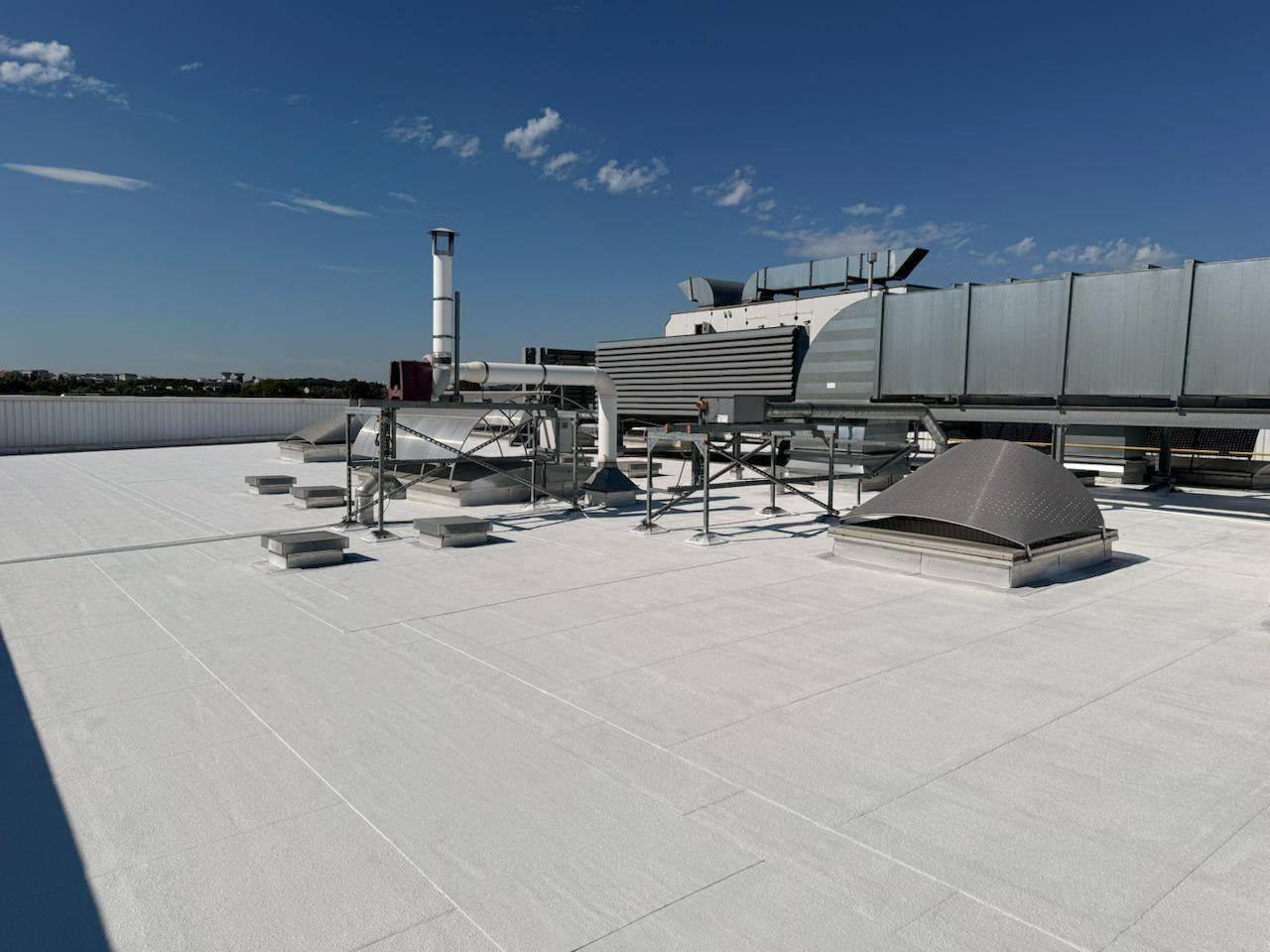 Factory roof treated with a cool roof coating, technical equipment in place